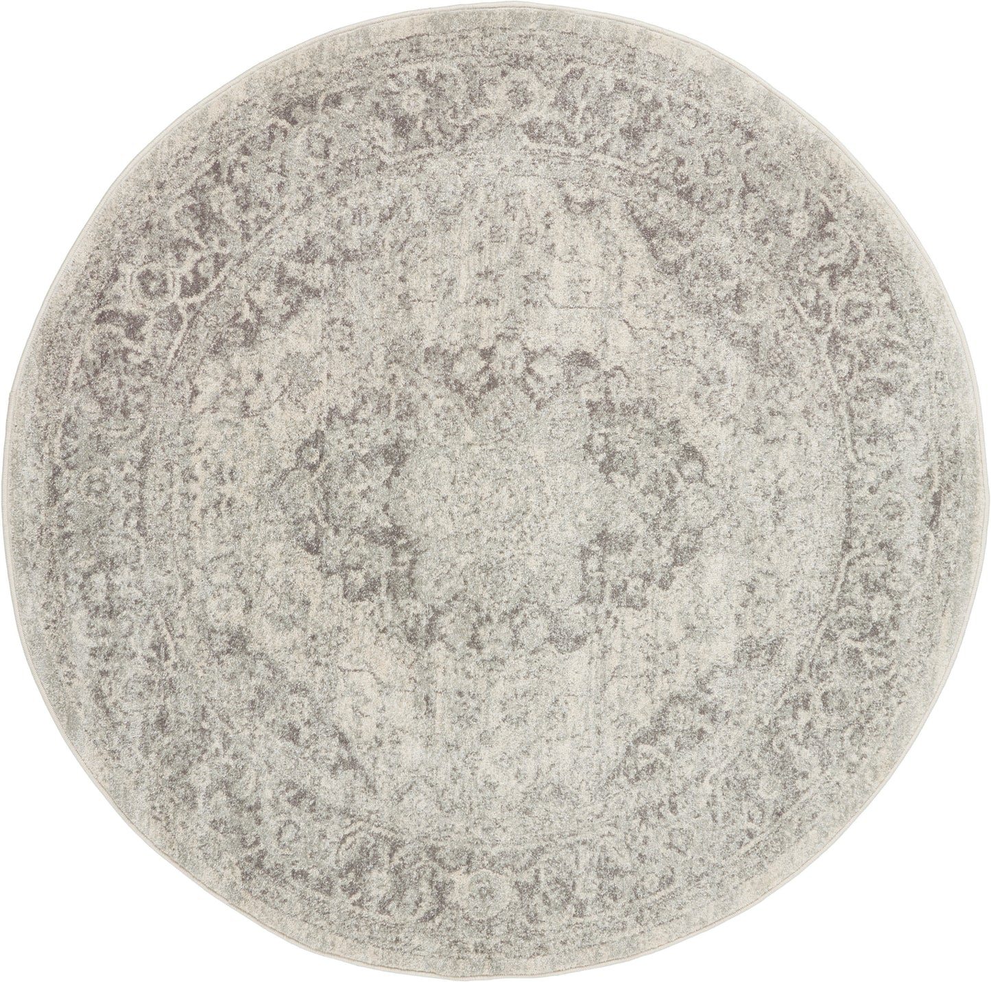 Round distressed beige-gray oriental rug with a faded central medallion and decorative border.