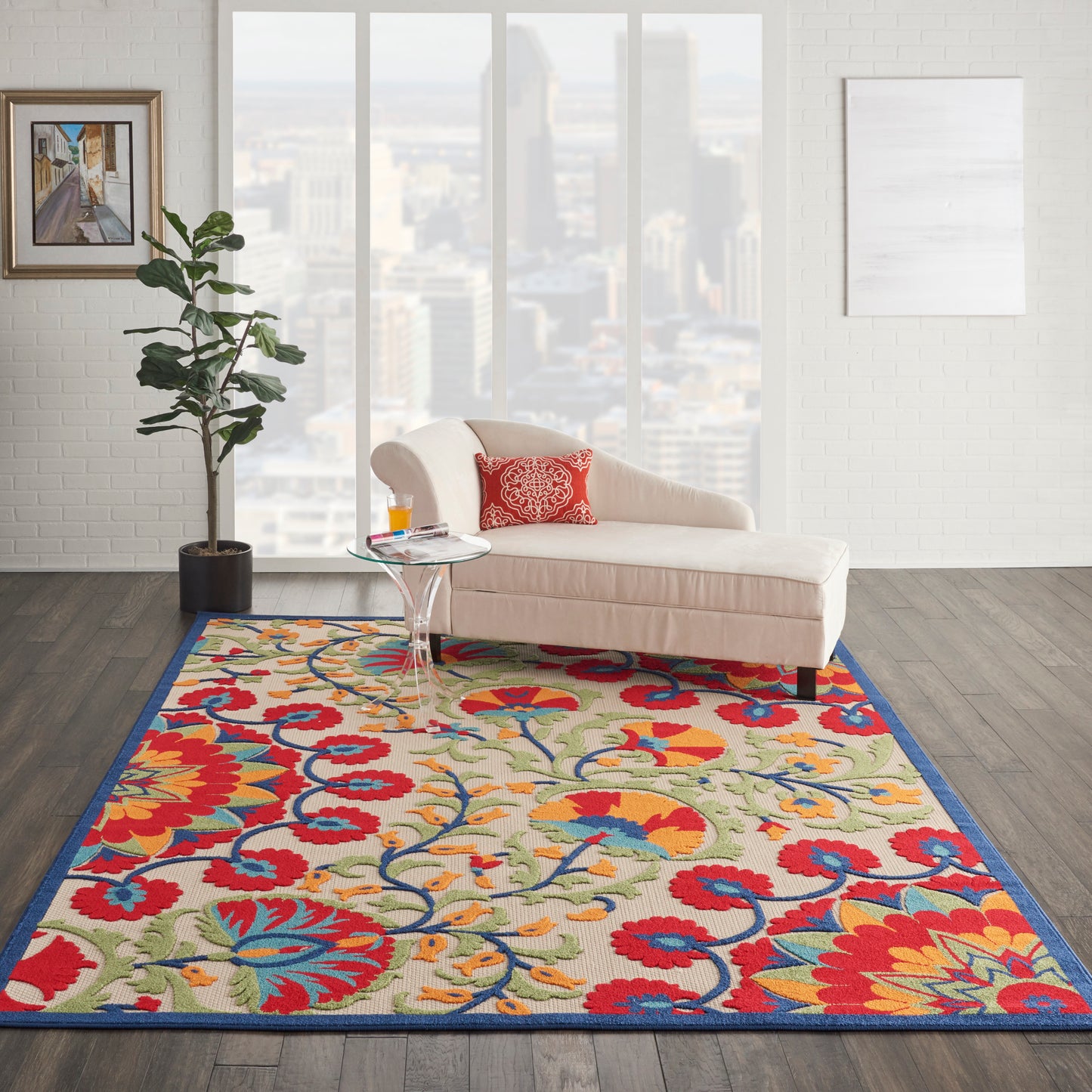 Vibrant floral area rug with red, blue, yellow hues in a modern living room; beige curved sofa and glass coffee table.