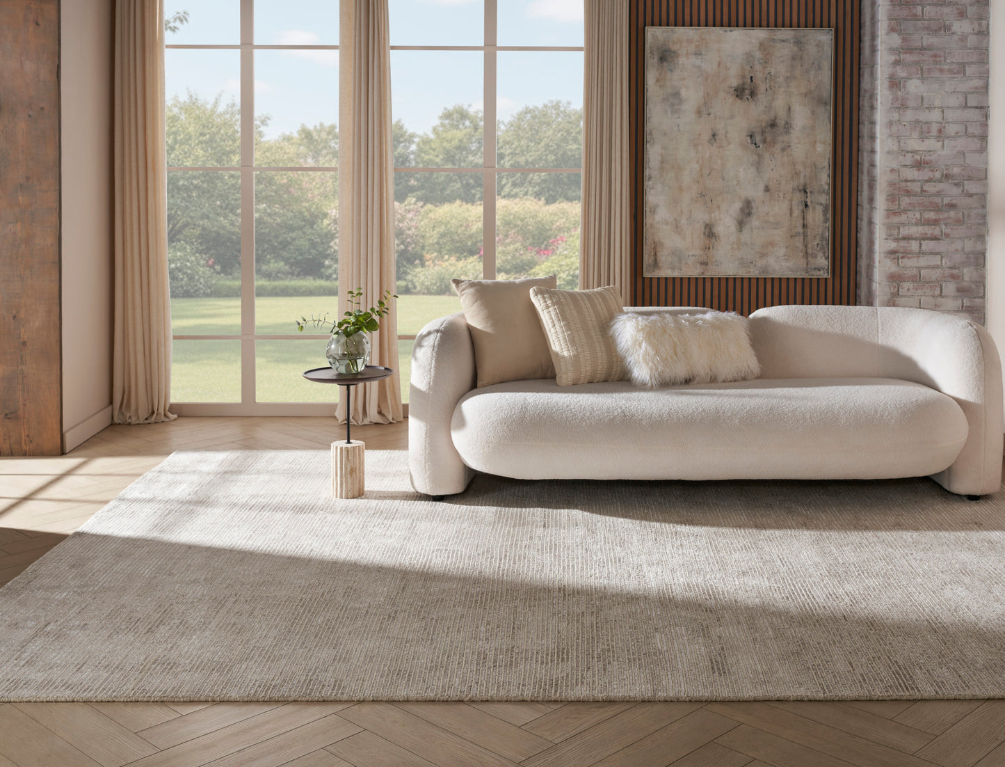 Cream curved fabric sofa with plush cushions in a sunlit contemporary living room with a beige rug