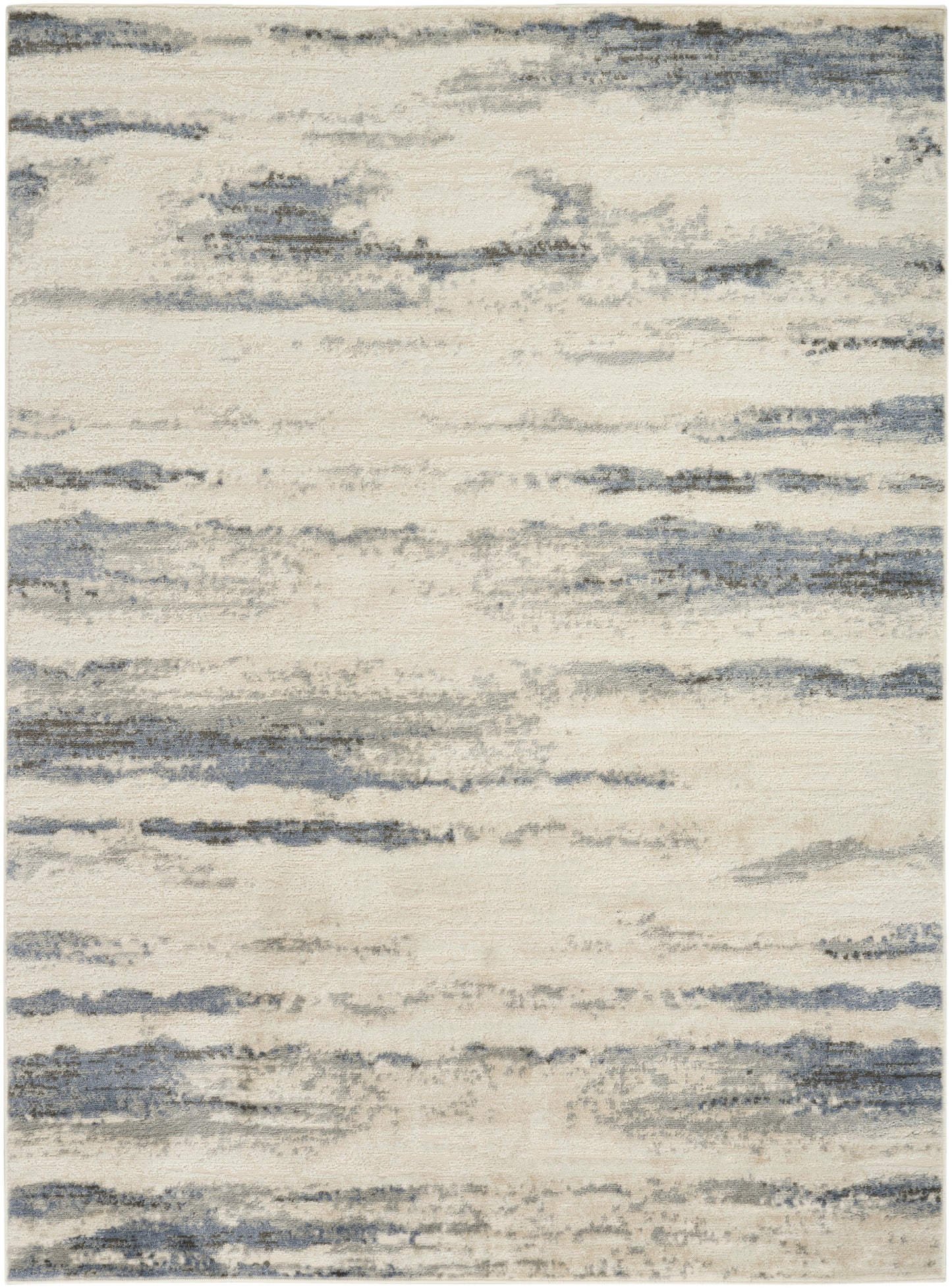 Rectangular beige rug with muted blue-gray brushstrokes in a watercolor-style pattern.