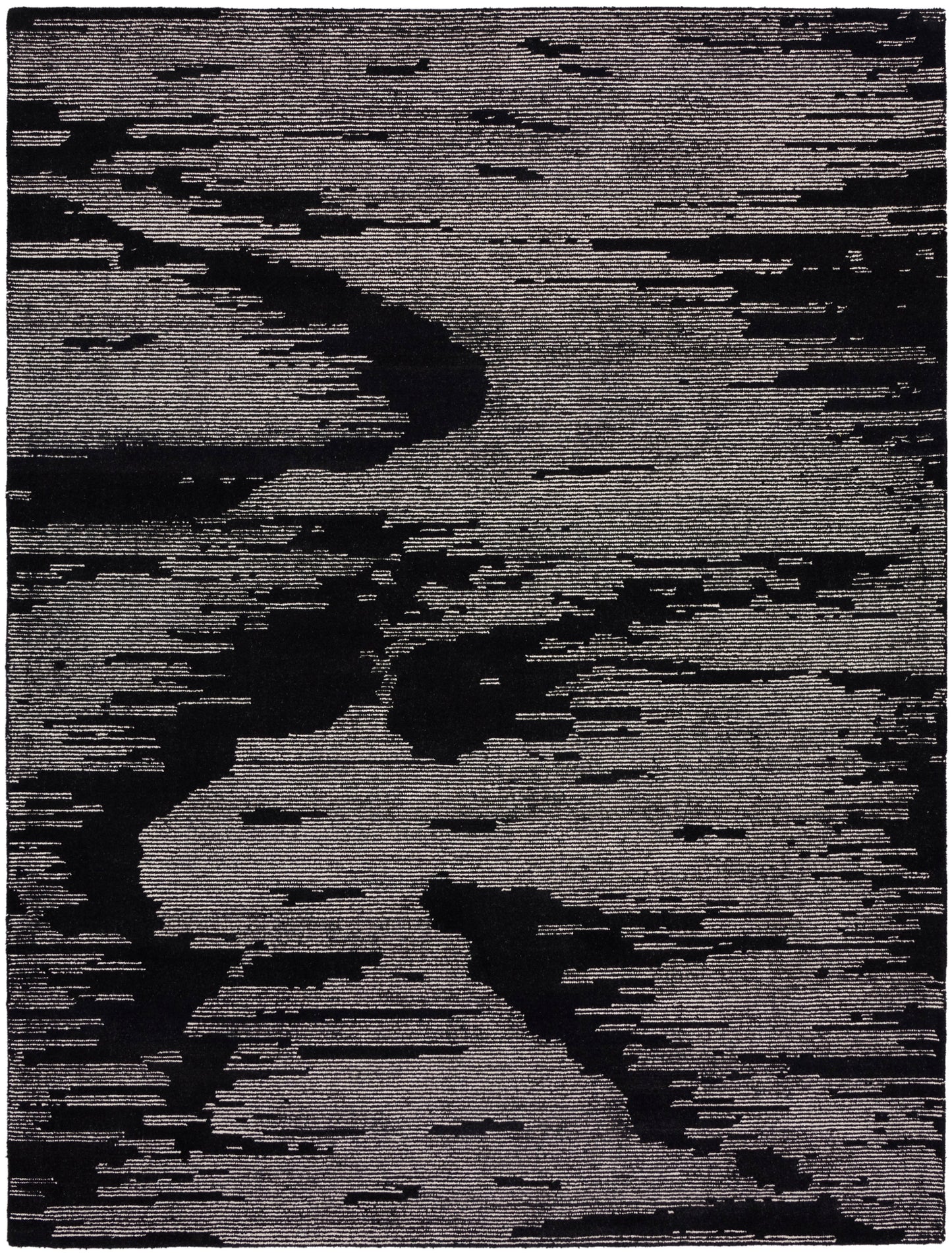 Rectangular area rug with charcoal-black and gray abstract pattern; modern woven decor.