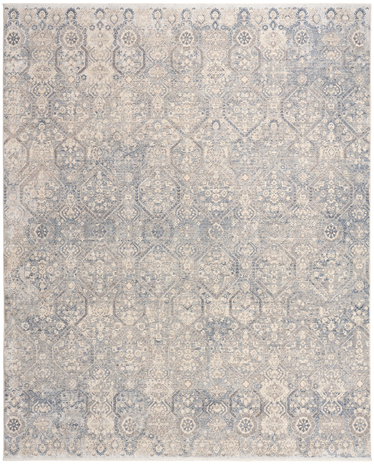 Rectangular distressed blue and beige oriental-style area rug with faded geometric floral medallions.