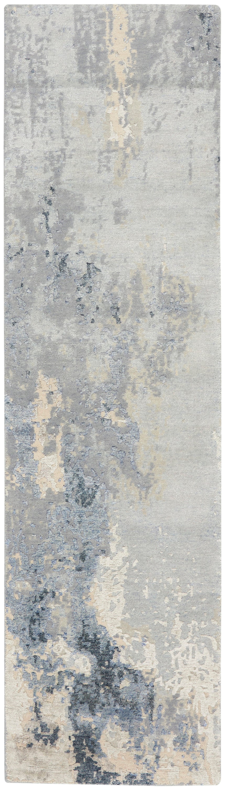 Rectangular runner rug in blue-gray and beige with painterly, washed pattern.