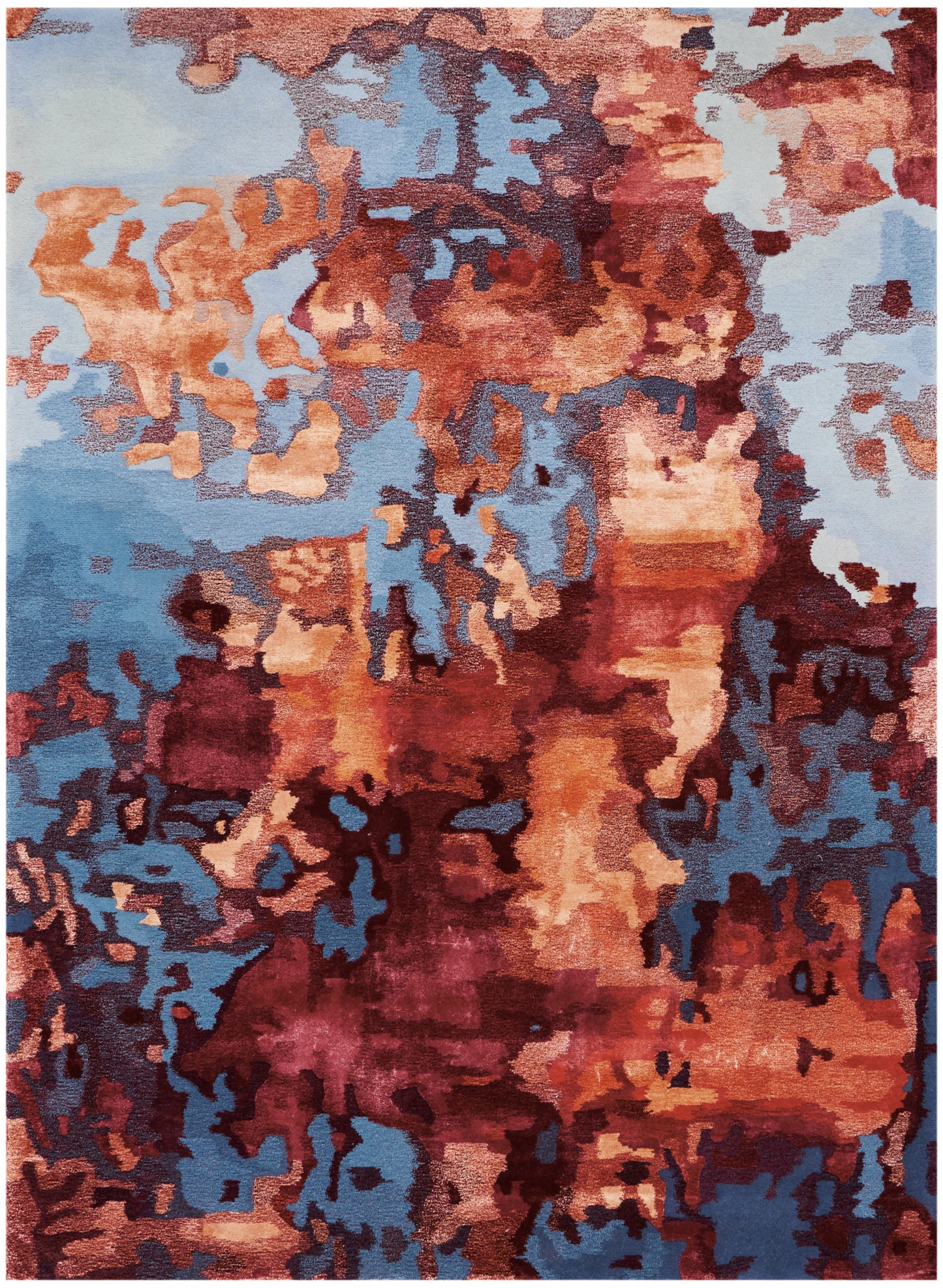 Abstract area rug in orange, rust, peach and blue hues with an organic blotchy mosaic.