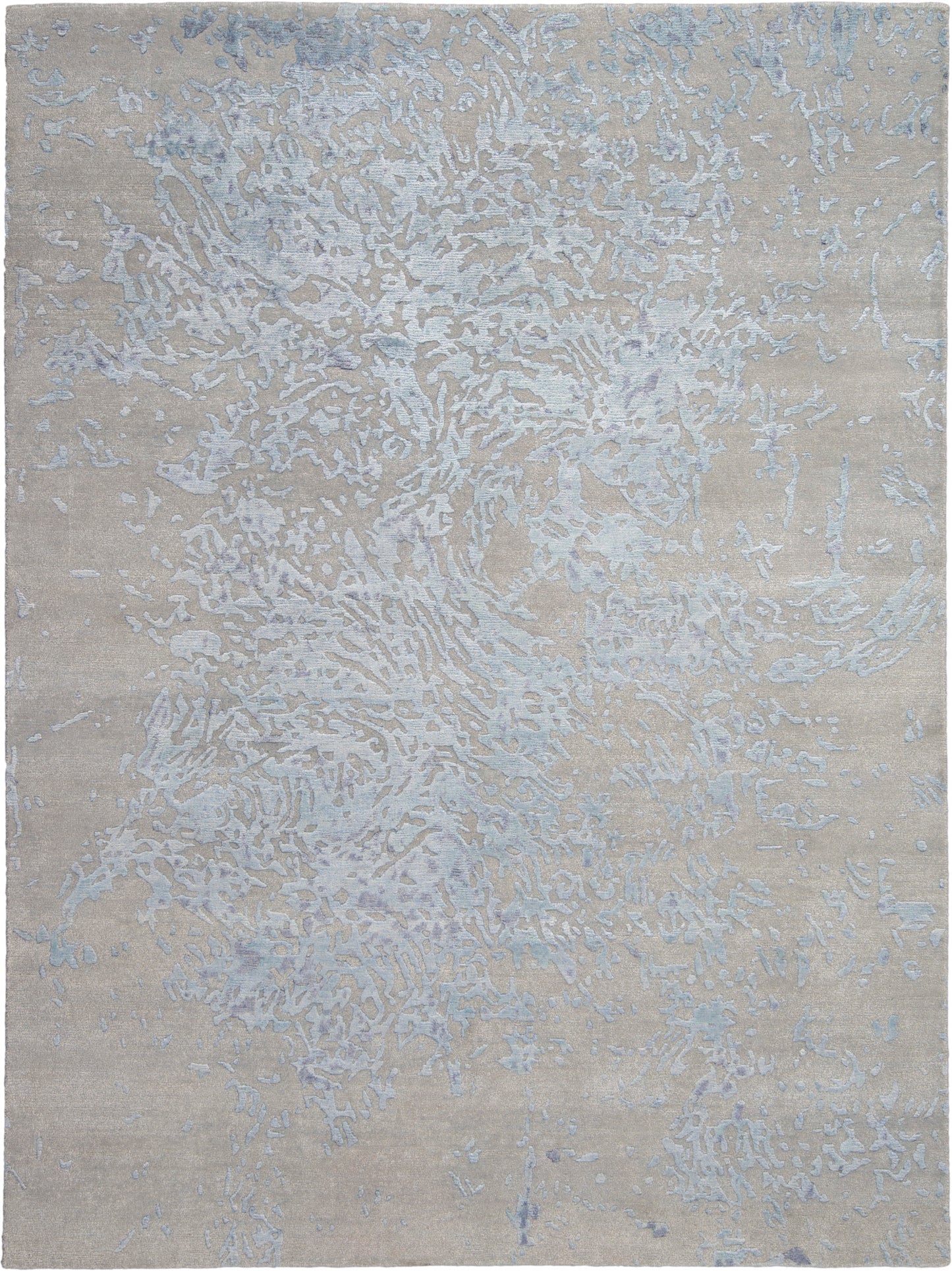 Beige area rug with pale blue-gray abstract pattern, modern textured surface, versatile for living spaces.