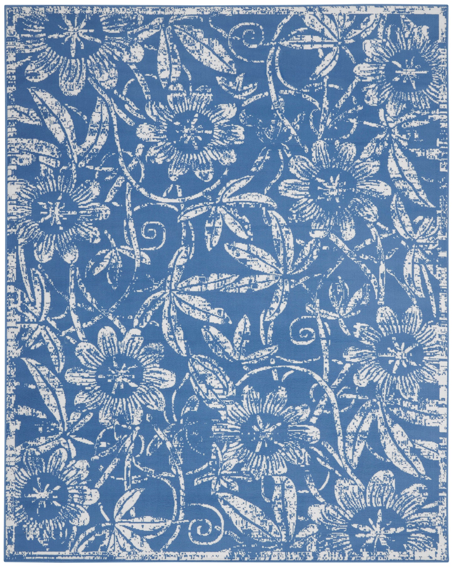Blue rug with an intricate white floral damask pattern of vines and blossoms.