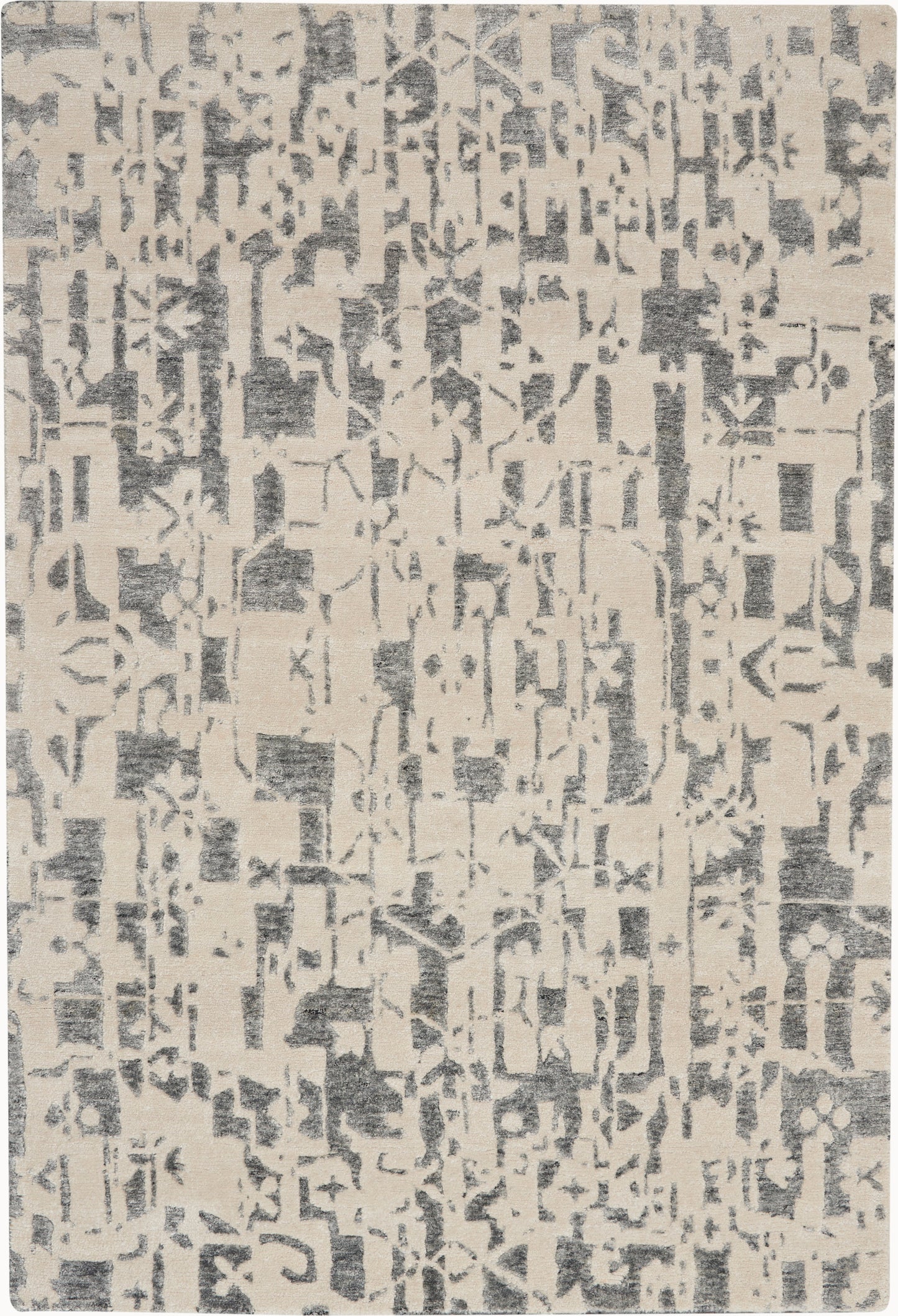 Beige area rug with an abstract charcoal gray distressed pattern; rectangular, soft woven texture.