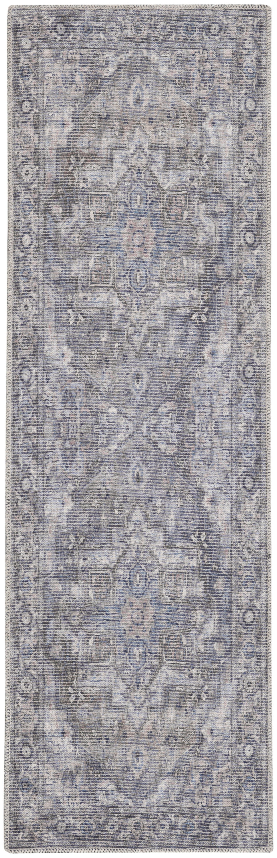 Rectangular blue-gray distressed Persian-style rug with central medallion and floral border; vintage woven look.