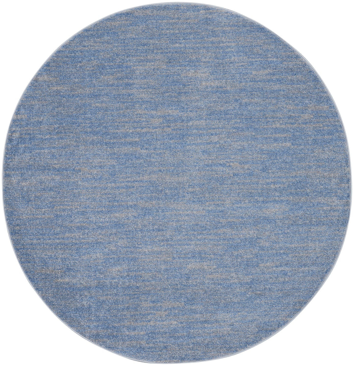 Round blue textured rug with marled denim finish and beige flecks.