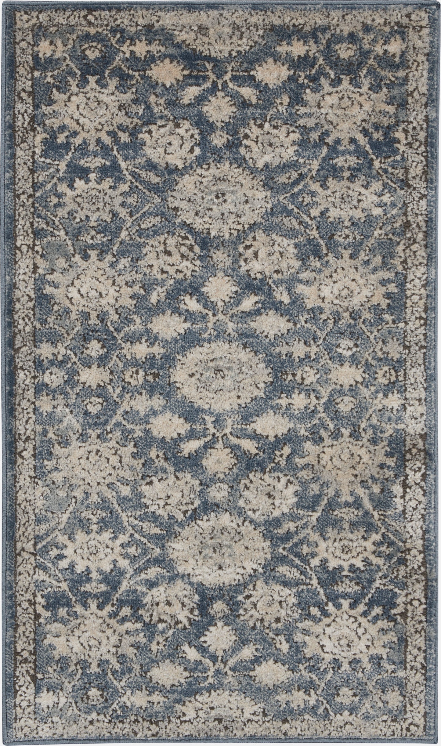 Rectangular blue and beige distressed floral rug; woven, traditional Persian-inspired medallion pattern for living room.