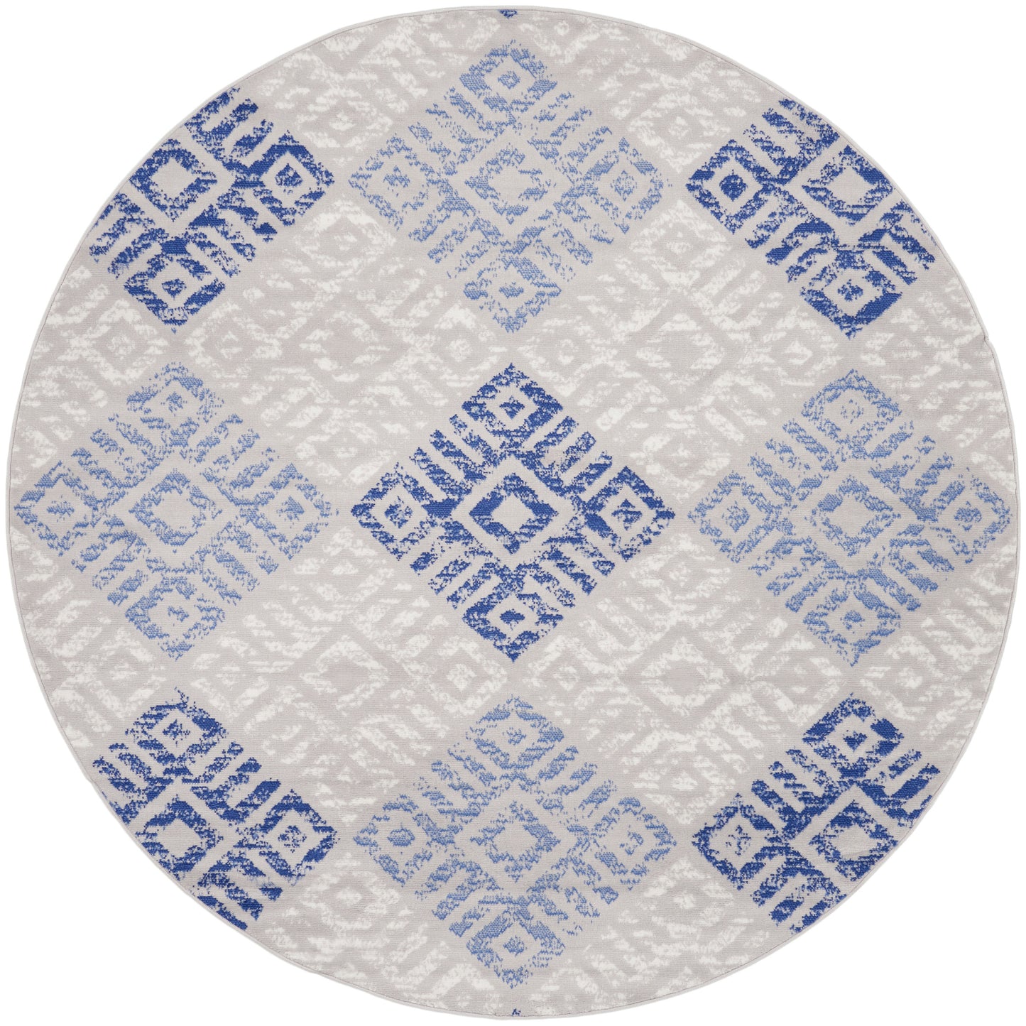 Round rug with blue-gray geometric diamond tile pattern on cream background, modern flat-weave.