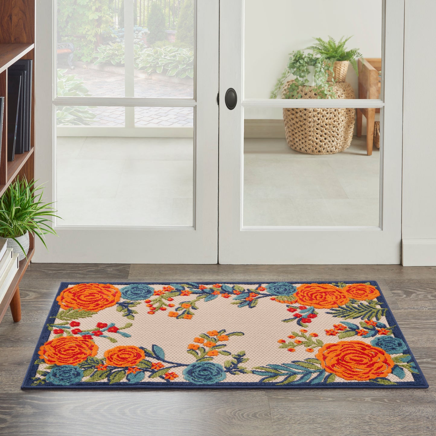 Rectangular floral doormat with orange roses, blue blooms, green leaves and a dark blue border for entryways.
