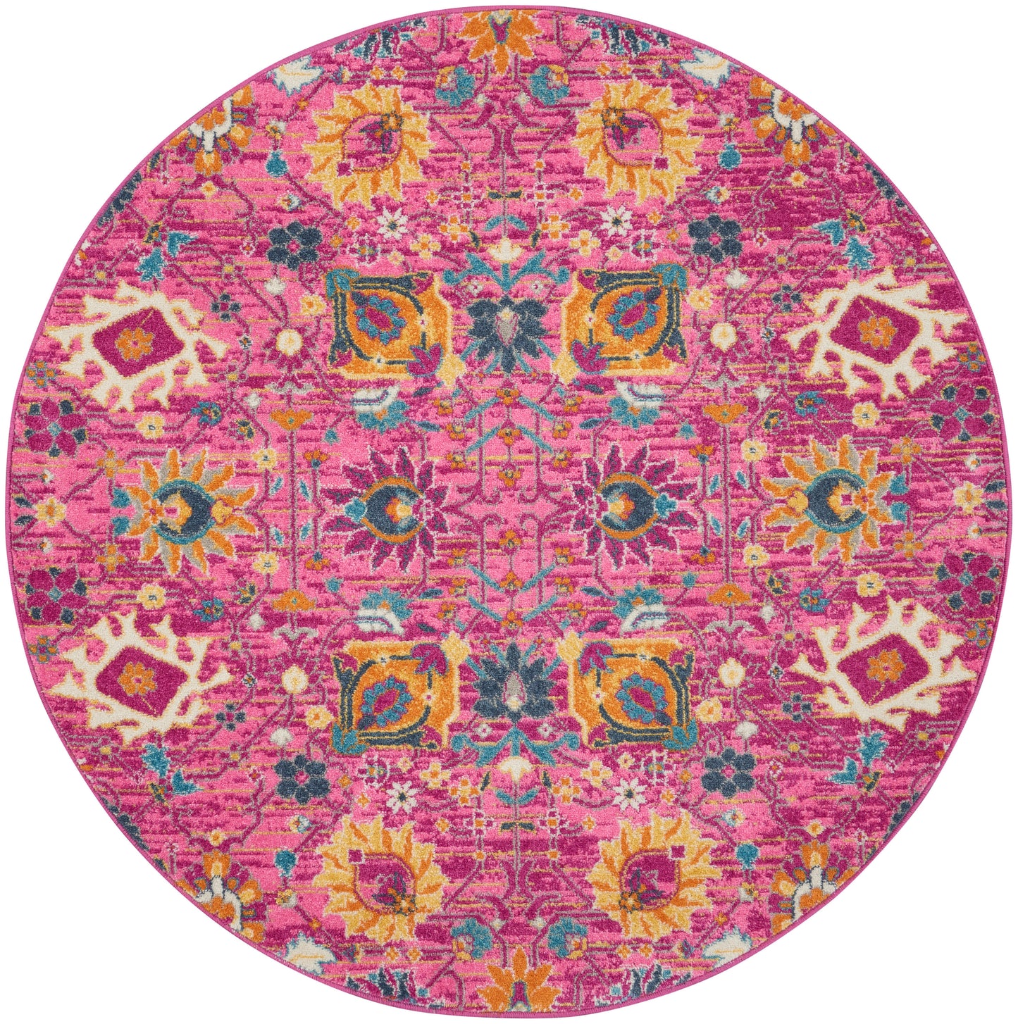 Round pink rug with vibrant kaleidoscopic floral and geometric pattern in yellow, teal, orange and cream.