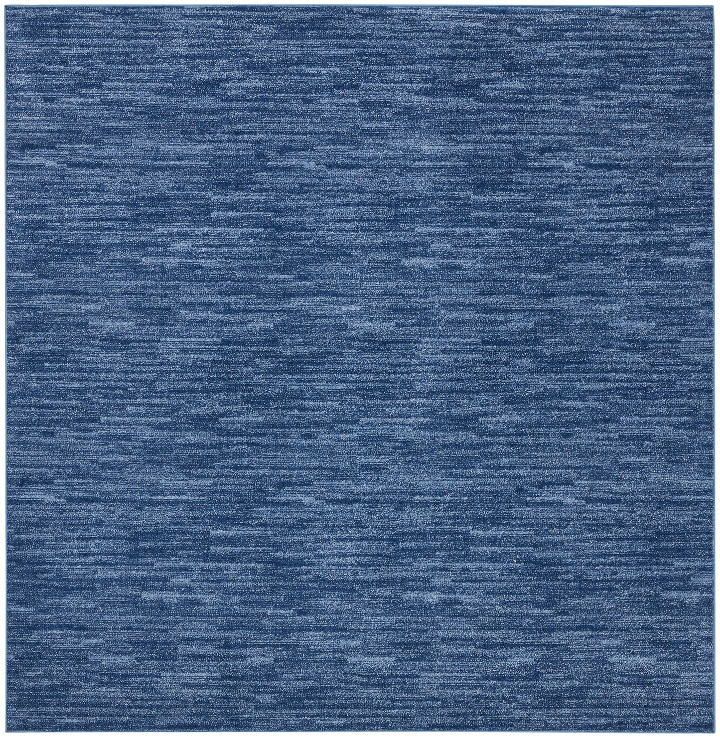 Blue heathered outdoor rug with marled texture and soft micro-pile; square denim shade.