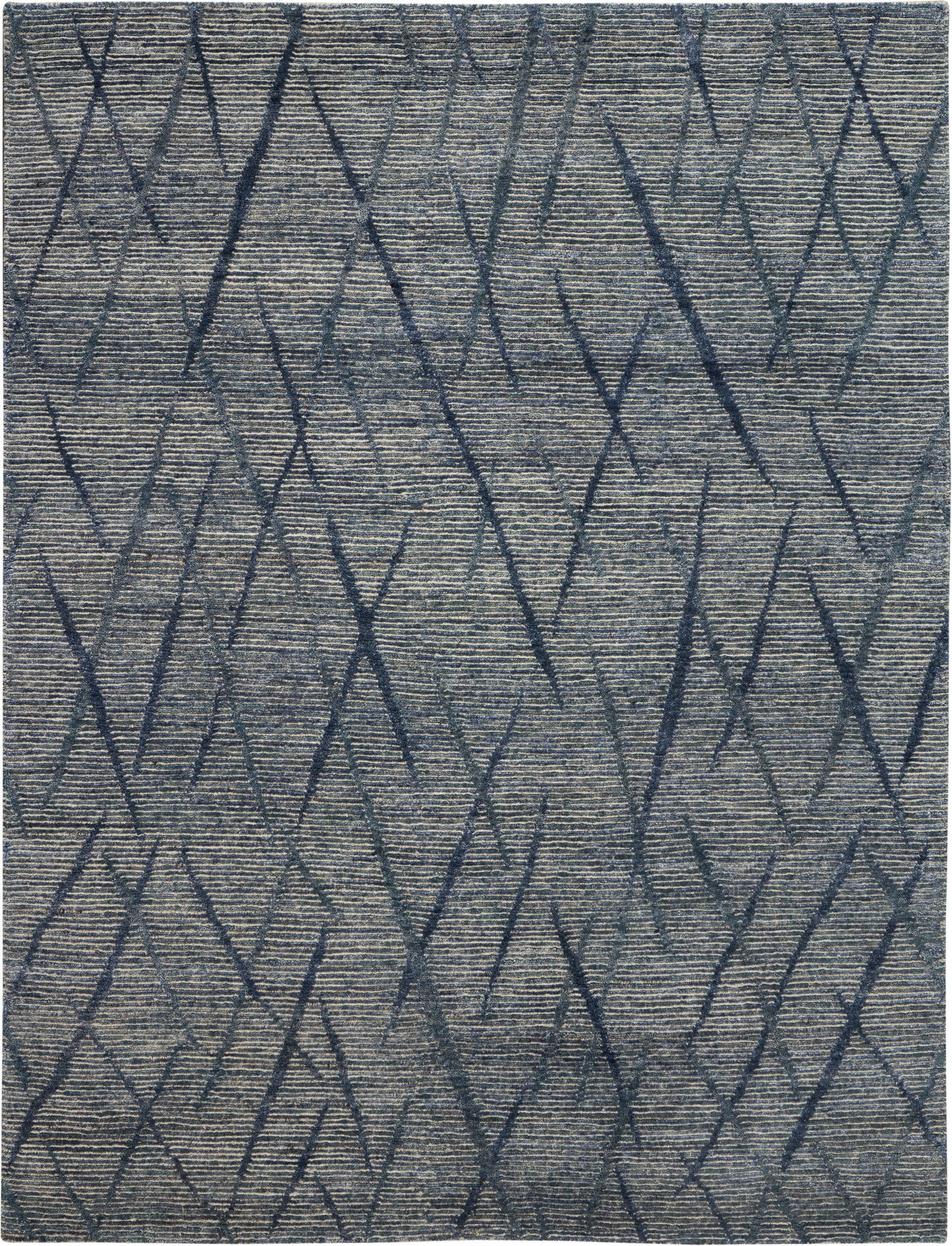 Blue-gray rug with dark navy geometric diamonds on a textured woven surface.