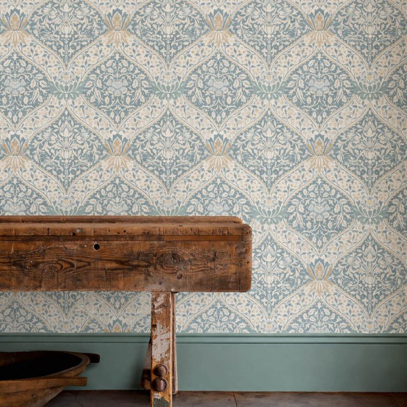 Norbury Wallpaper by Morris & Co. in Woad and Linen featuring an elegant ogee damask pattern with detailed floral borders, leafy motifs, and subtle linen-inspired texture. A sophisticated Arts & Crafts heritage wallpaper design inspired by William Morris style, perfect for traditional and modern luxury interiors including bedrooms, living rooms, dining rooms, and studies.