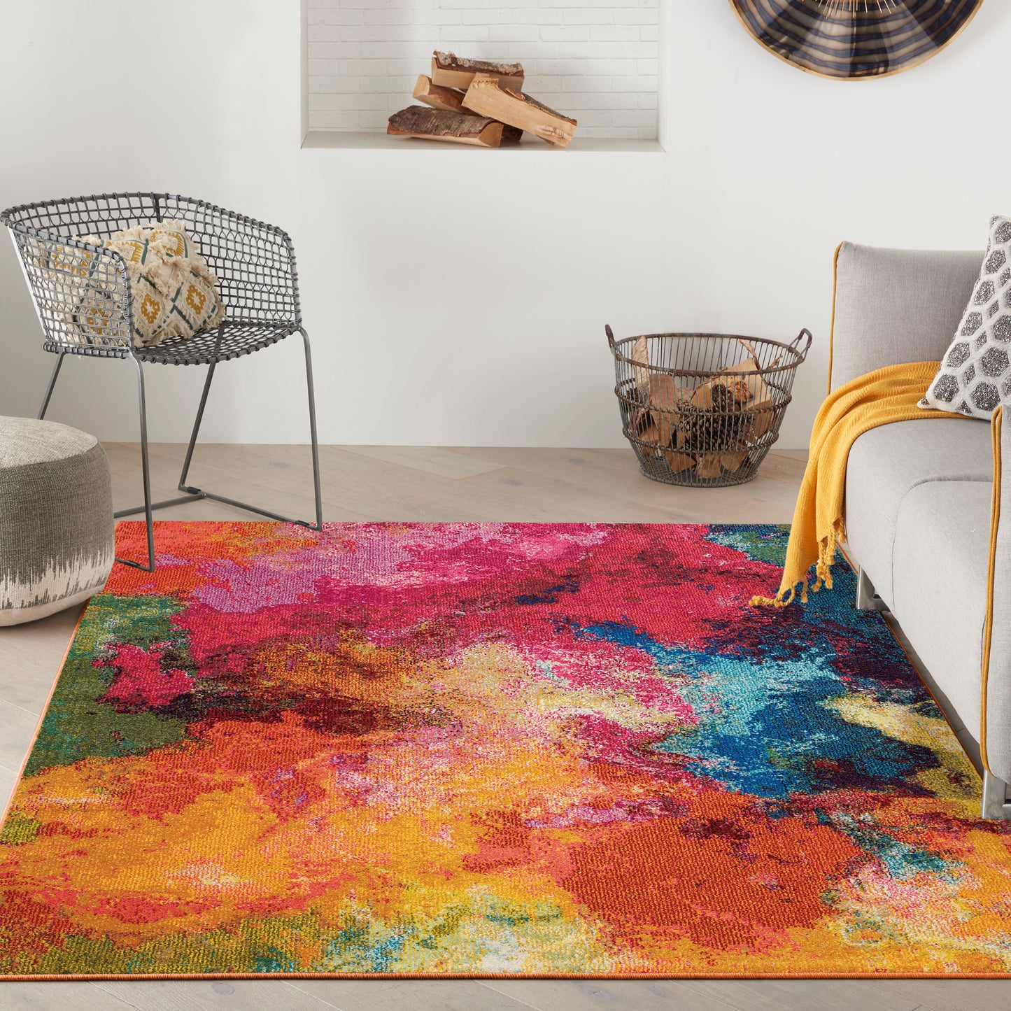 Rectangular colorful abstract rug with vivid reds, oranges, pinks, blues and greens in a modern living room.
