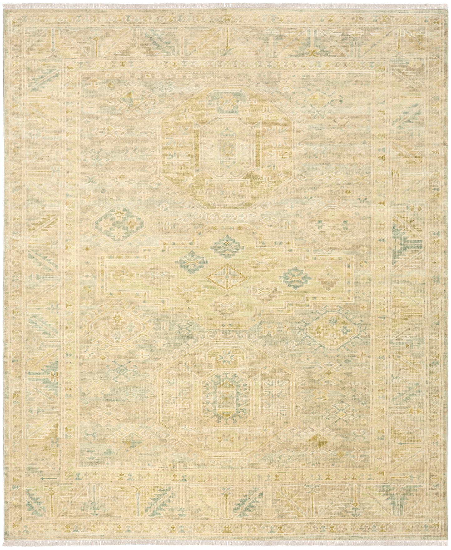 Rectangular area rug in cream with pale sage blue and tan distressed geometric medallion motifs and border.