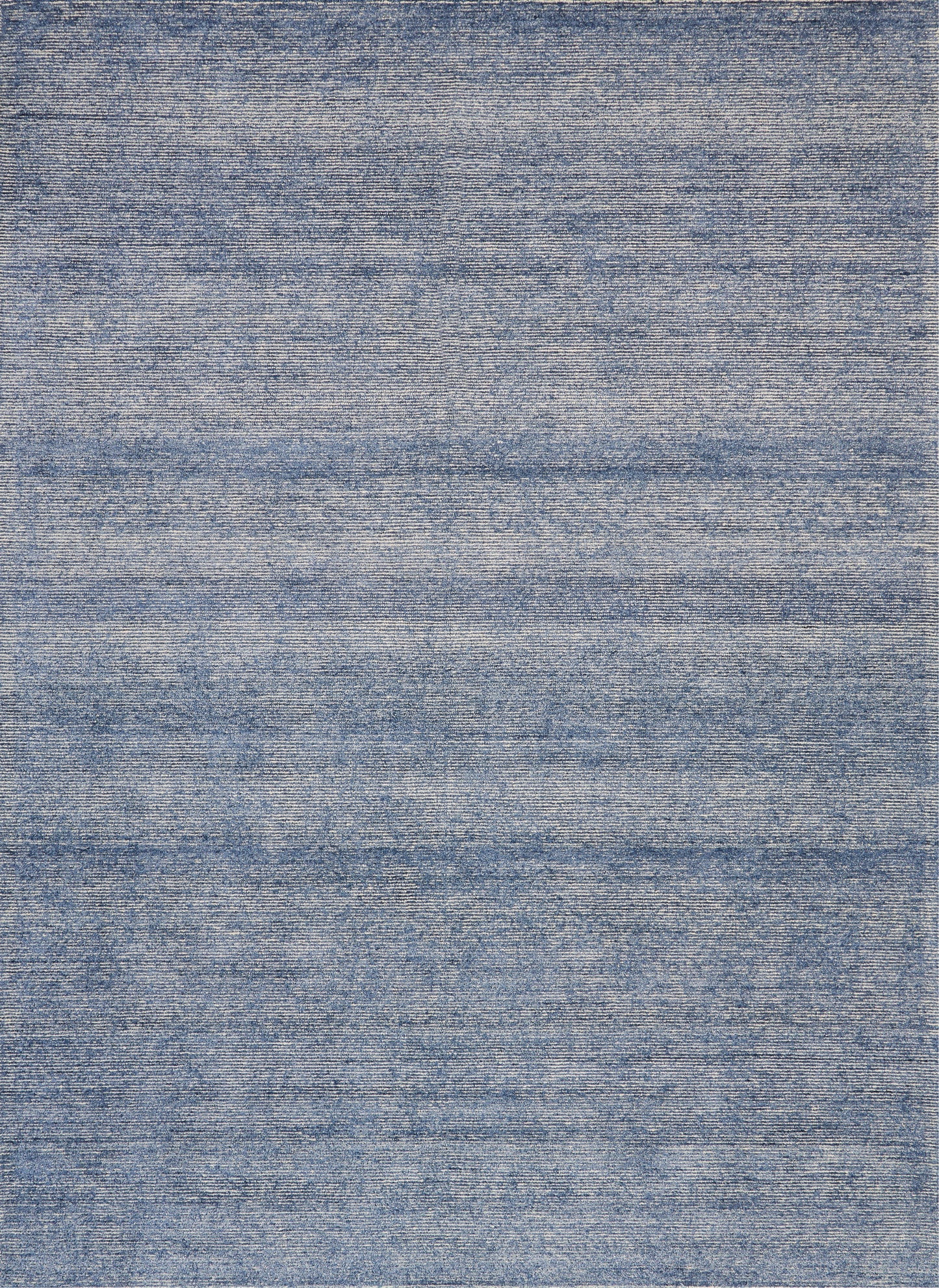 Blue denim-style flat-weave rug with subtle horizontal striations and a soft, casual look.