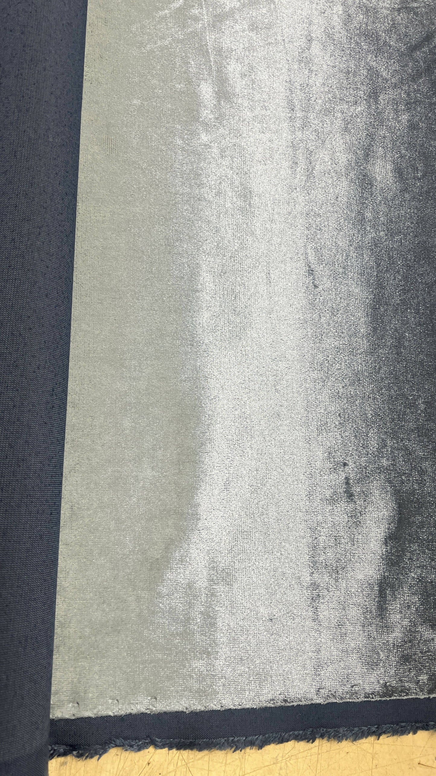 Textured fabric showcasing a gradient from dark navy to shiny silver, ideal for stylish upholstery or accessories.