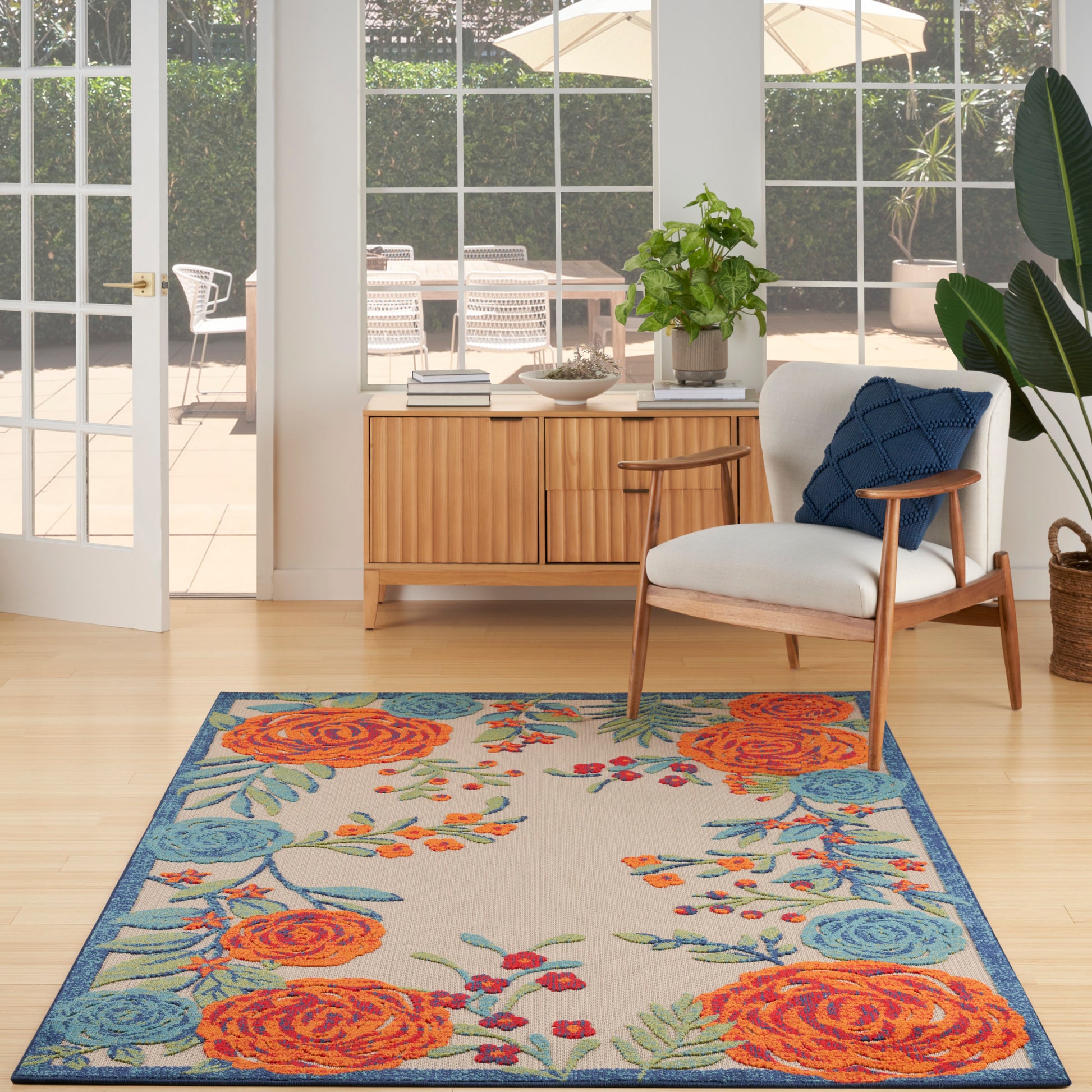 Rectangular outdoor rug (6' x 9') with orange roses, teal leaves and blue border.
