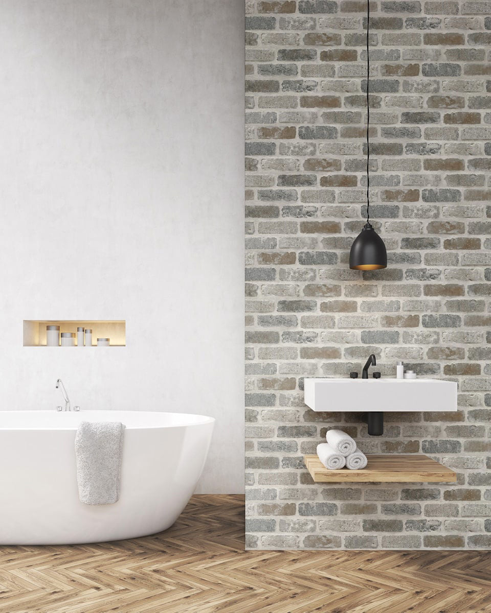 Realistic faux brick peel and stick wallcovering in gray and rust tones, Washed Brick design by NextWall, exposed brick look wallpaper for industrial accent walls, removable and washable wallcovering for modern loft-style interiors
