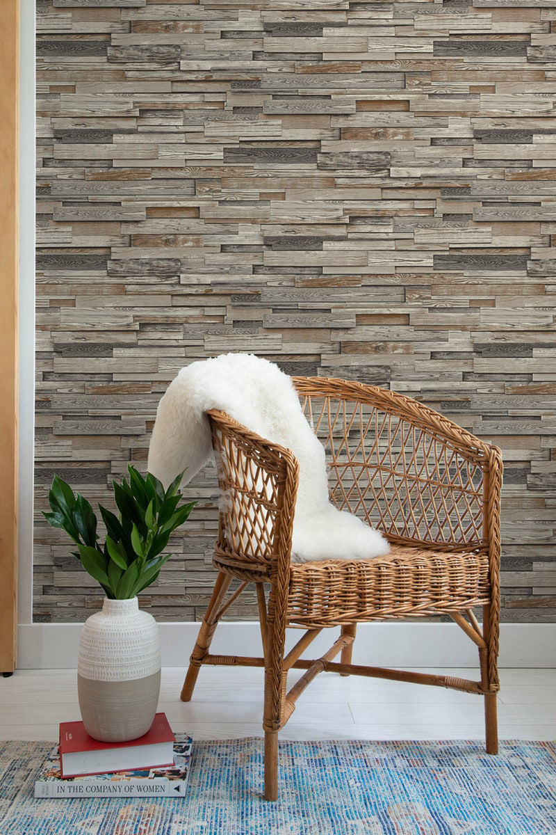 NextWall Reclaimed Wood Plank peel and stick wallpaper in charcoal and brown with realistic weathered wood boards. Removable, washable wallpaper for farmhouse, rustic, industrial, and modern accent walls in living rooms, bedrooms, offices, and entryways.