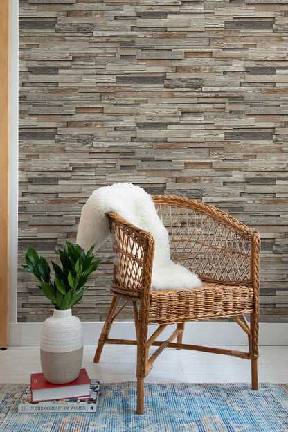 NextWall Reclaimed Wood Plank peel and stick wallpaper in charcoal and brown with realistic weathered wood boards. Removable, washable wallpaper for farmhouse, rustic, industrial, and modern accent walls in living rooms, bedrooms, offices, and entryways.