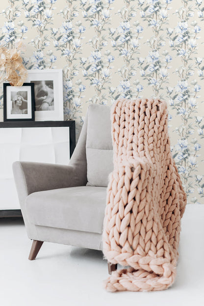 Blue and white magnolia floral wallpaper featuring blooming magnolia flowers, delicate trailing branches, and a timeless botanical pattern. Magnolia Trail Peel and Stick Wallpaper in Linen and French Blue creates a serene accent wall for bedrooms, living rooms, dining rooms, home offices, and traditional or coastal-inspired interiors. Easy-to-install removable wallpaper with elegant floral styling.