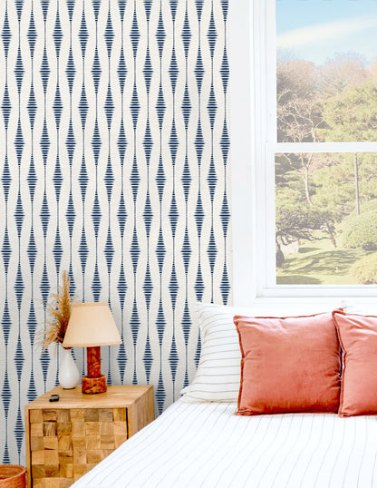 Navy Blue and Linen Striped Ikat Peel and Stick Wallpaper with a textured geometric pattern inspired by traditional ikat textiles. Features soft vertical stripes in rich navy and neutral linen tones, creating a sophisticated accent wall for bedrooms, living rooms, dining rooms, entryways, home offices, coastal homes, and modern farmhouse interiors. Removable, washable, and renter-friendly wallpaper design.