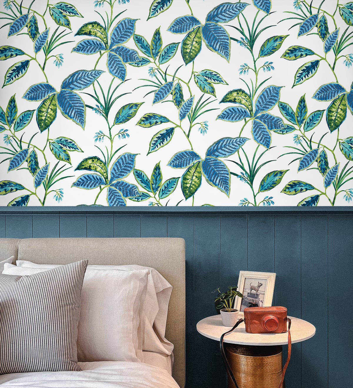 Boho Leaf Trail Peel and Stick Wallpaper in Lagoon featuring a soft, flowing botanical pattern of trailing leaves and subtle floral accents in layered blue tones. This bohemian-inspired wallpaper creates a relaxed, nature-inspired backdrop for accent walls in bedrooms, living rooms, nurseries, bathrooms, entryways, and home offices. Removable peel and stick design that is renter-friendly, washable, and easy to apply for effortless interior updates.
