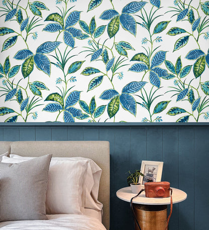 Boho Leaf Trail Peel and Stick Wallpaper in Lagoon featuring a soft, flowing botanical pattern of trailing leaves and subtle floral accents in layered blue tones. This bohemian-inspired wallpaper creates a relaxed, nature-inspired backdrop for accent walls in bedrooms, living rooms, nurseries, bathrooms, entryways, and home offices. Removable peel and stick design that is renter-friendly, washable, and easy to apply for effortless interior updates.