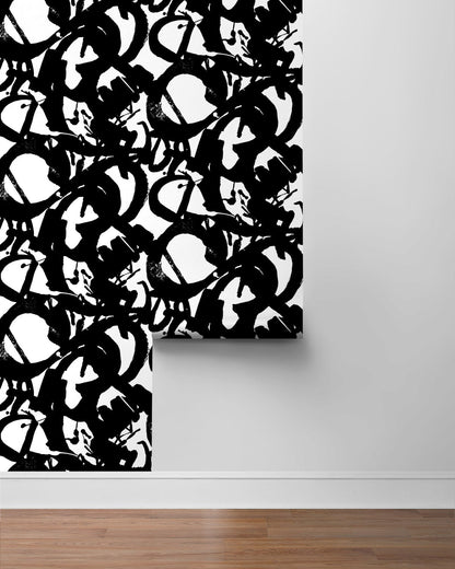 Onyx black and white peel-and-stick wallpaper featuring oversized, irregular inkblot brushstrokes with an expressive hand-painted appearance. The bold abstract pattern creates a dramatic statement wall for modern, contemporary and artistic interiors.