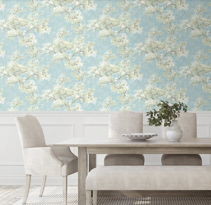 Blue floral peel and stick wallpaper featuring graceful cherry blossom branches, soft green foliage, and a serene garden-inspired pattern. Cherry Blossom Grove wallpaper in Blue Mist and Green Tea adds a fresh botanical look to accent walls, bedrooms, nurseries, living rooms, and modern cottage-style interiors. Easy-to-install removable wallpaper ideal for renters and home makeovers.