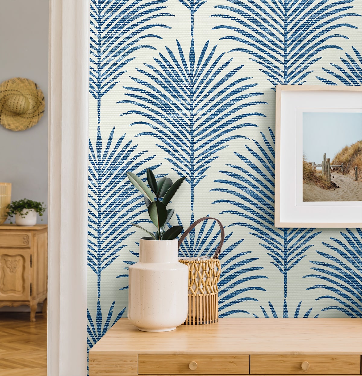 Coastal blue palm peel and stick wallpaper featuring tropical botanical leaves, removable wallcovering for beach house decor, accent walls, and modern coastal interior design.