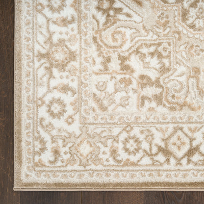 Beige cream patterned oriental rug with floral motifs and decorative border on dark wood floor.