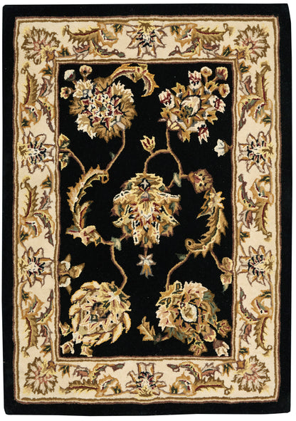 Rectangular traditional oriental rug with black center and ivory floral border; gold-toned vines.