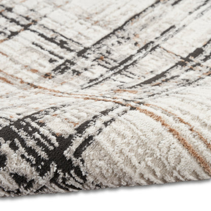 Cream shag rug with black geometric lines and light brown accents; plush, textured pile.