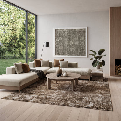 Neutral living room with cream sectional, tan cushions, round wood coffee table, abstract art, rug, plant, and large windows.