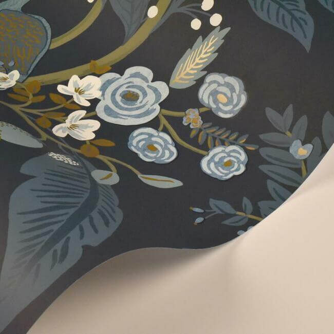Rifle Paper Co. Peacock Wallpaper in Navy featuring graceful peacocks surrounded by flowering branches, vibrant blossoms and layered emerald foliage. This detailed floral and bird wallpaper creates a sophisticated garden-inspired backdrop for bedrooms, dining rooms, living rooms and accent walls.