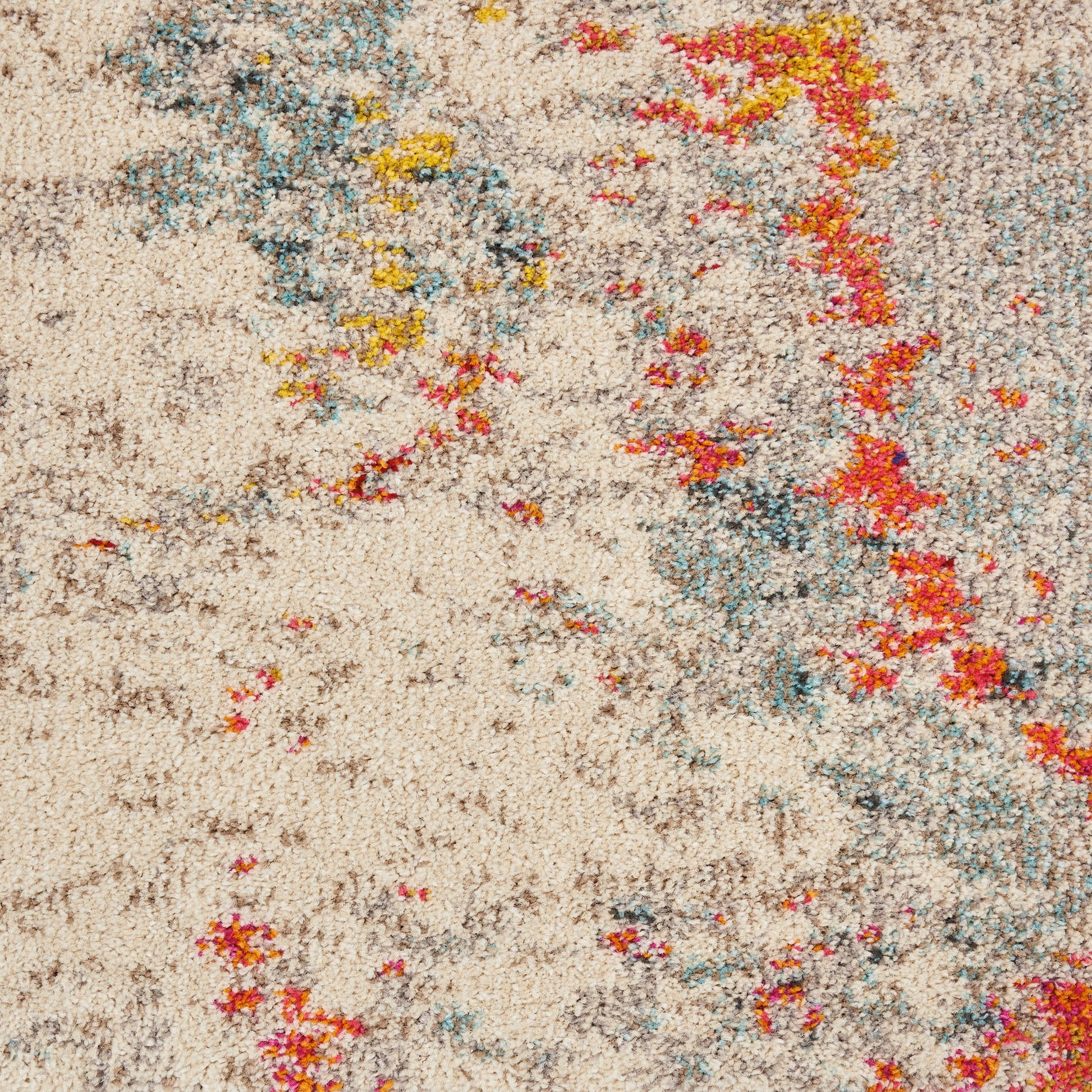 Beige shag rug with abstract multicolor patches in blue-teal, yellow, and red for modern floor décor.