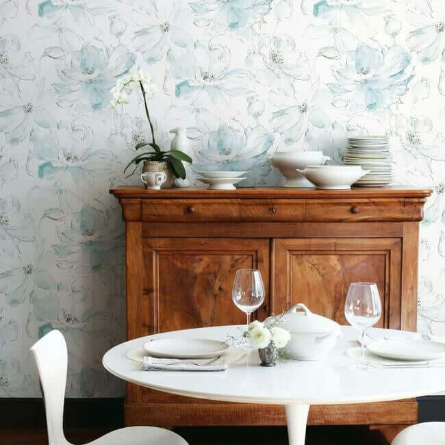 Elegant blue and green floral wallpaper featuring large hand-sketched blossoms on a white background, creating a light and refreshing botanical look for bedrooms, living rooms, dining rooms, bathrooms, and cottage-inspired home decor.