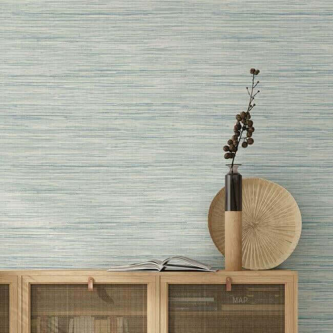 Sky blue Bahiagrass wallpaper with a natural grasscloth-inspired texture and subtle organic irregularities, creating a calm, sophisticated look for coastal, farmhouse, and modern interiors.