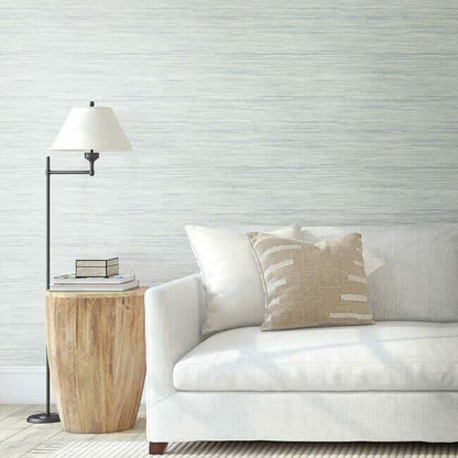 Sky blue textured wallpaper featuring a subtle woven grasscloth pattern with organic variations, creating a natural and sophisticated backdrop for coastal, farmhouse, beach-inspired, and contemporary home decor.