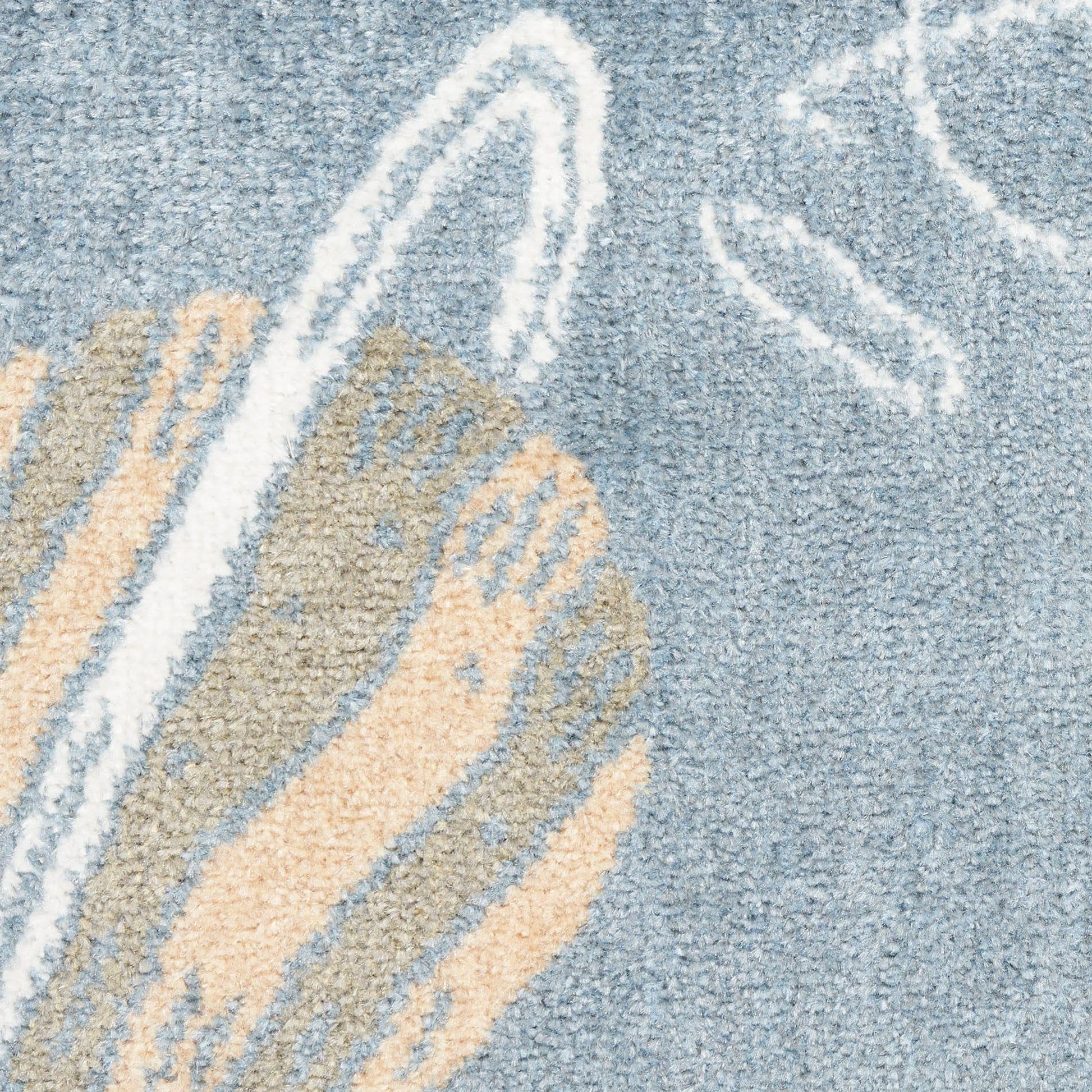 Blue area rug with beige and white abstract swirl pattern, soft plush pile.