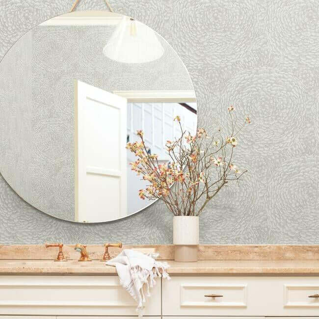 Floret Wallpaper in Linen featuring soft clusters of delicate floral blossoms with a light neutral color palette. Elegant floral wallpaper for bedrooms, living rooms, dining rooms, nurseries, hallways, powder rooms, and accent walls. Non-woven washable wallpaper ideal for cottage style, traditional interiors, transitional decor, French country homes, modern classic spaces, and neutral home decorating projects.