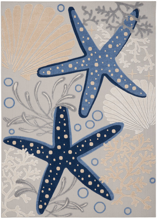 Coastal area rug with two blue starfish dotted in cream, beige shells, coral and bubbles on a gray-blue background.