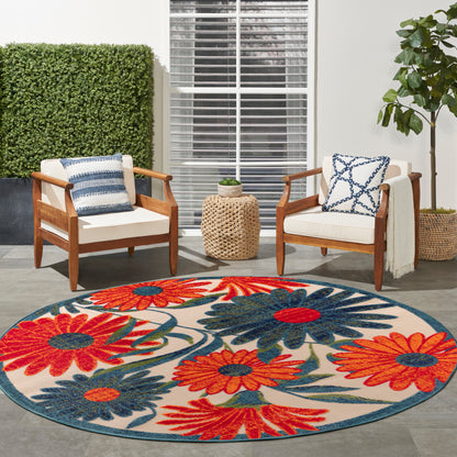 Round outdoor rug with bold red, orange & blue floral pattern, 5' round.