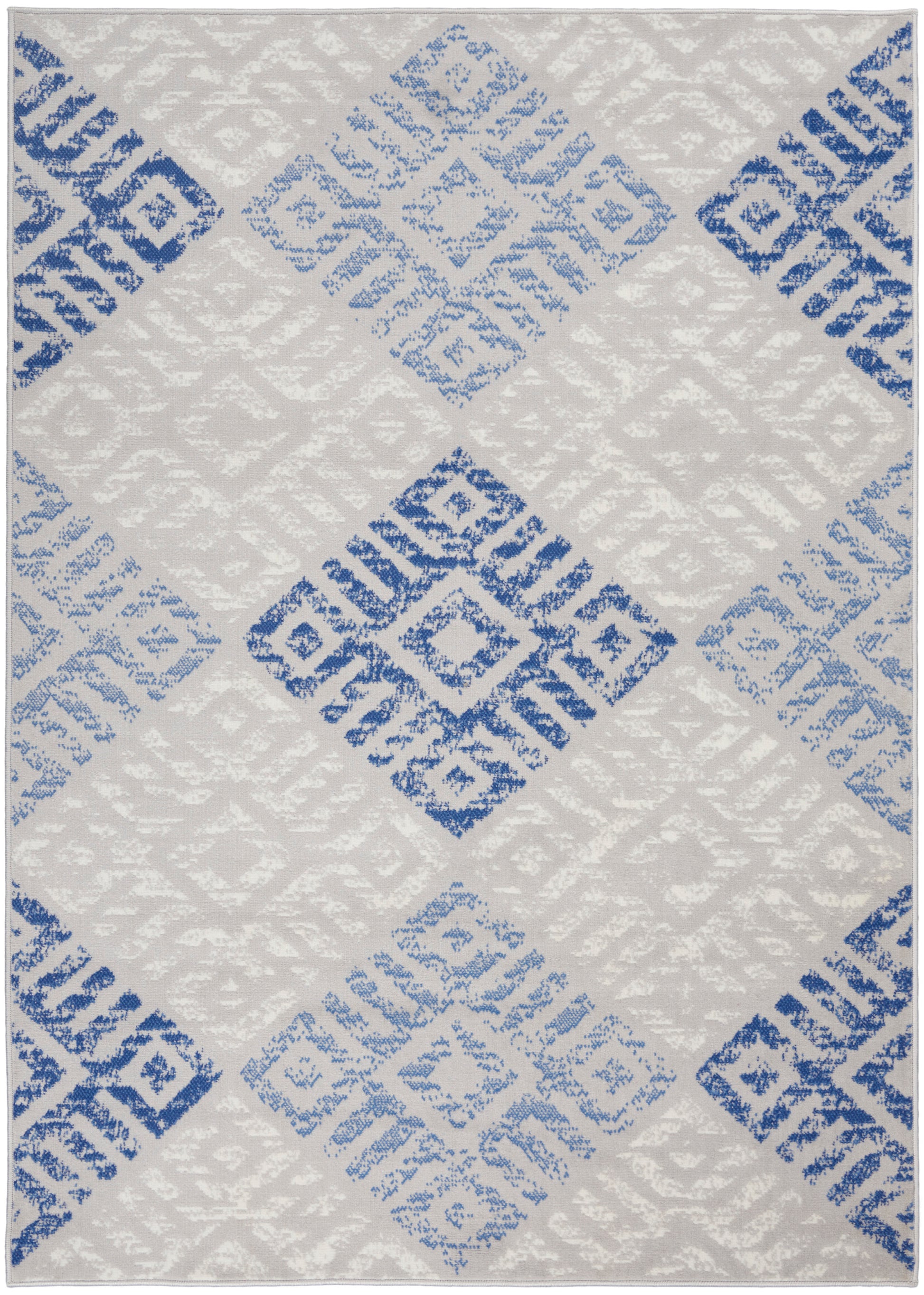 Light gray rug with blue diamond blocks in a modern distressed geometric pattern; soft textured weave.