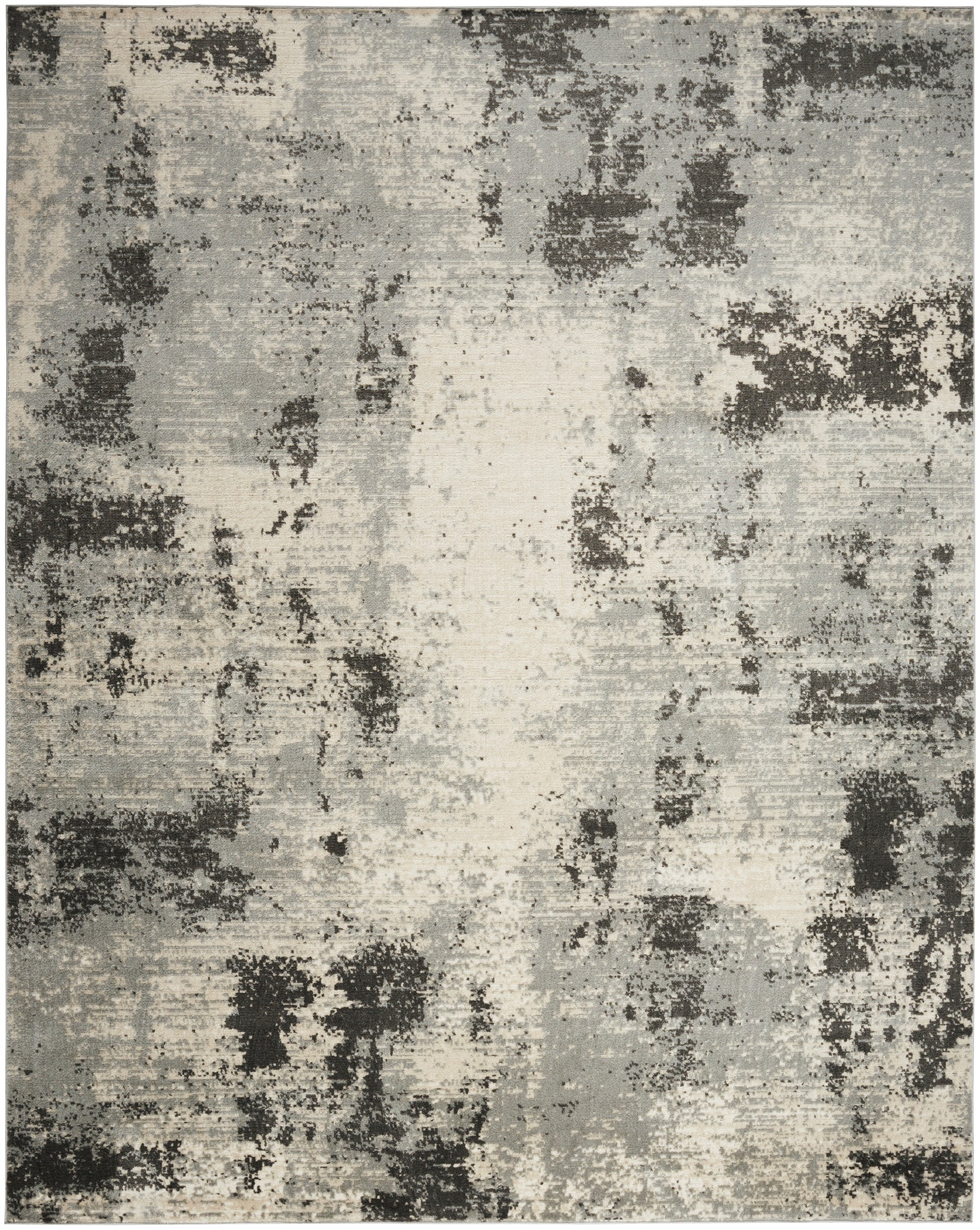 Abstract distressed area rug in gray, beige and charcoal with darker patches; modern, neutral decor.